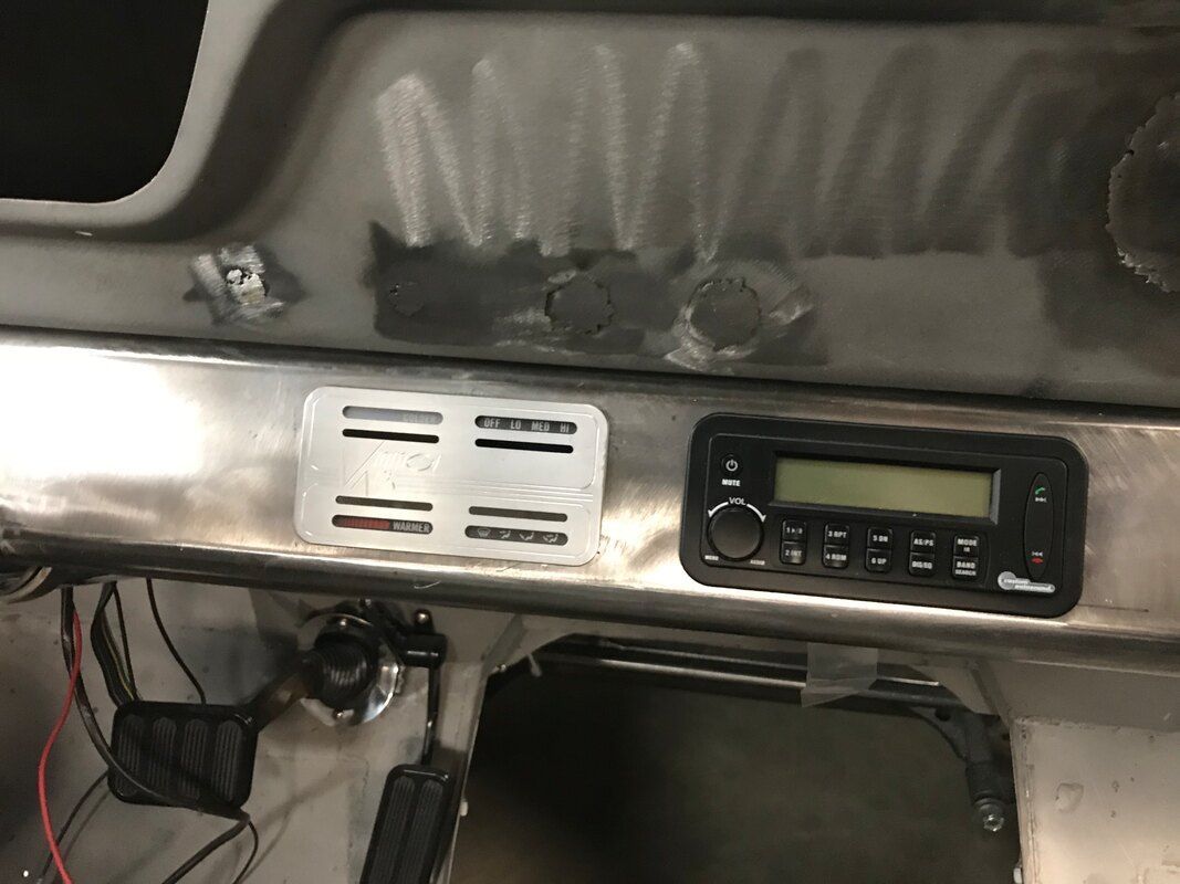 A radio is sitting on the dashboard of a car.