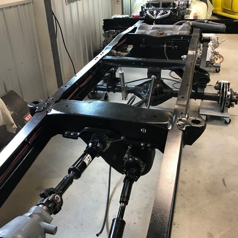 A frame of a car is being built in a garage