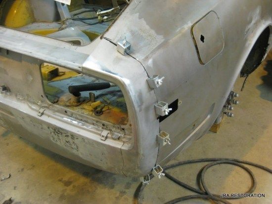 A car is being worked on with a hose attached to it