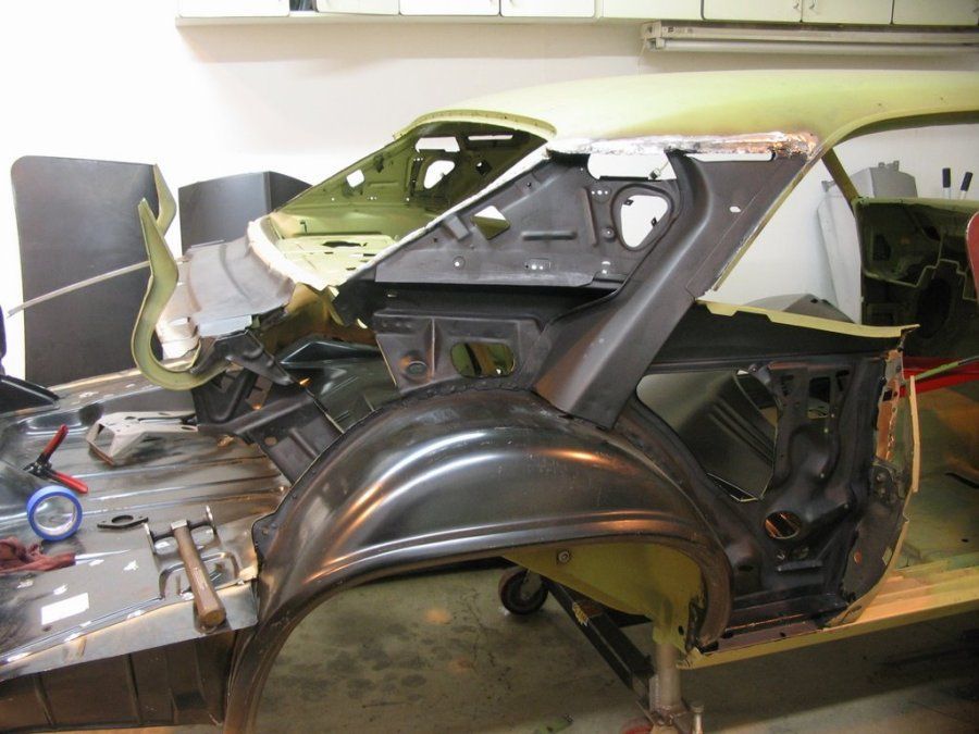 A car is being dismantled in a garage