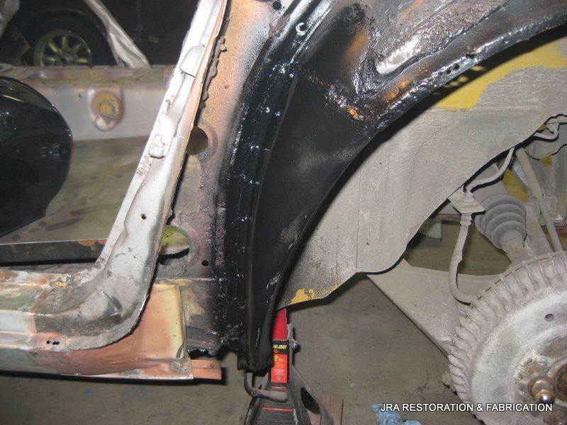 A close up of a car 's fender with the words 