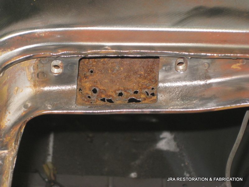 A piece of rusty metal with holes in it