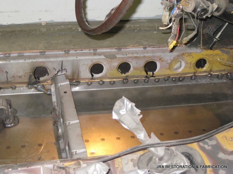 A piece of metal with holes in it is sitting on a table.