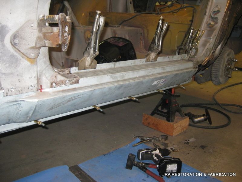 A car is being worked on by a company called restoration & fadt cation