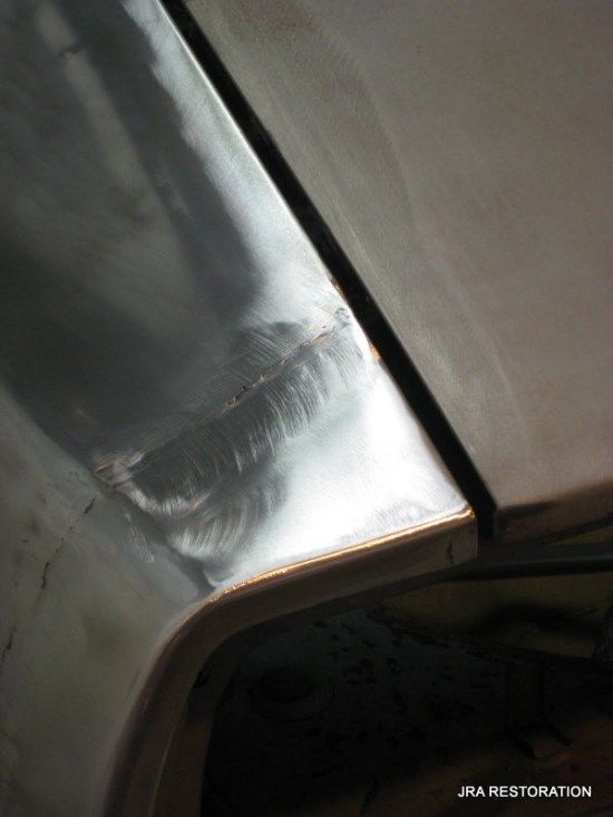 A close up of a piece of metal that says jra restoration