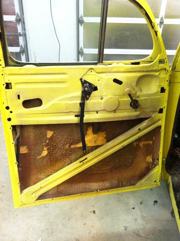 The inside of a yellow car with the door open