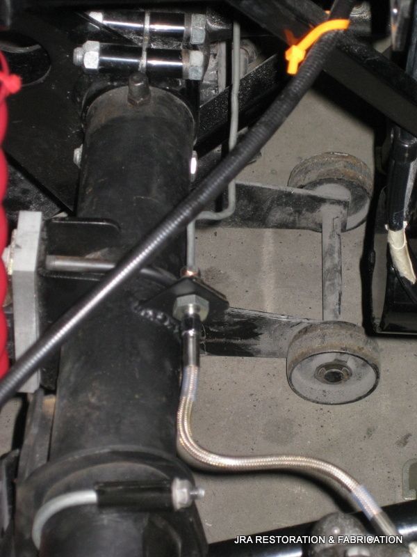 A close up of a black pipe with a hose attached to it