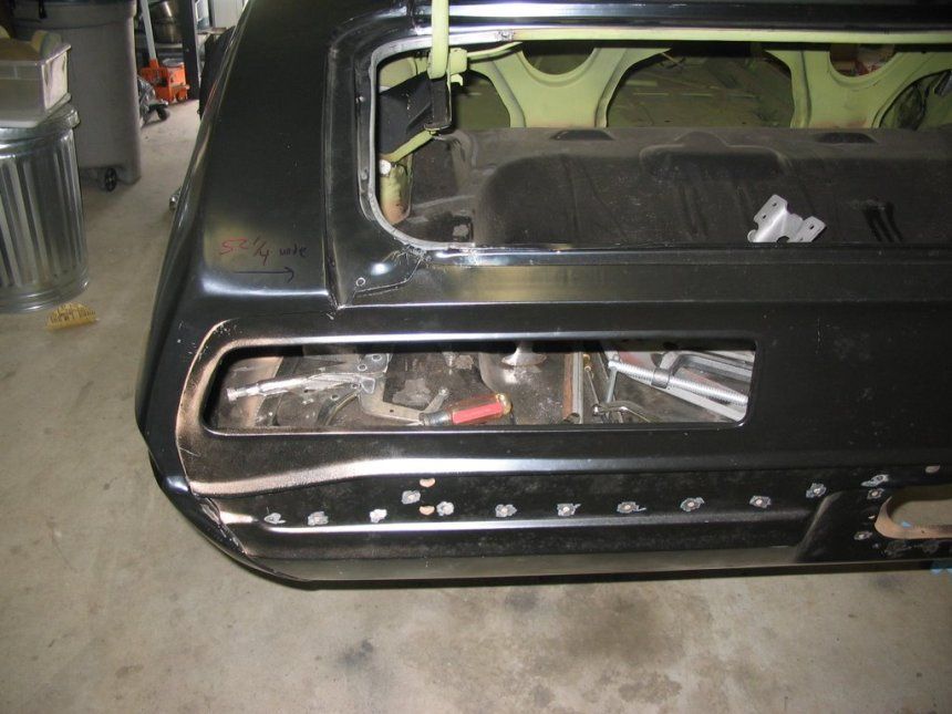 The back of a black car with the trunk open
