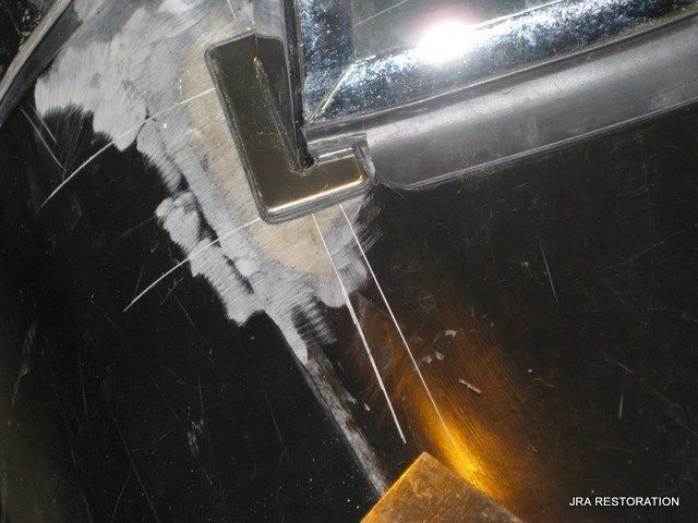 A close up of a metal object with a lot of scratches on it.