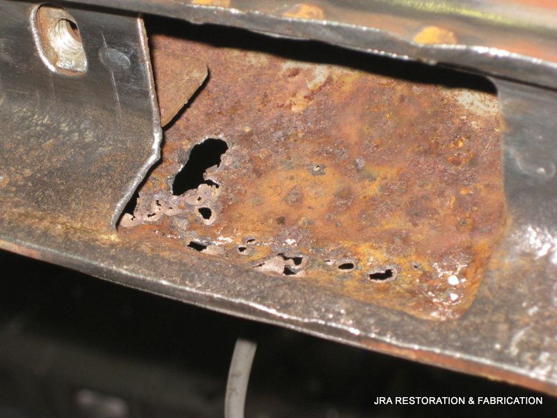 A piece of rusty metal with a hole in it