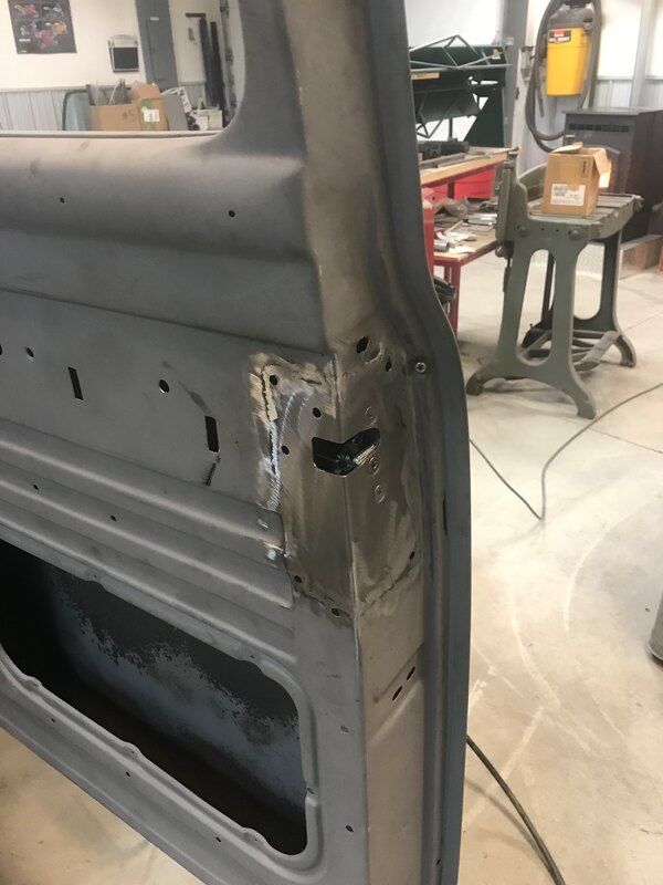 A car door is being repaired in a garage.