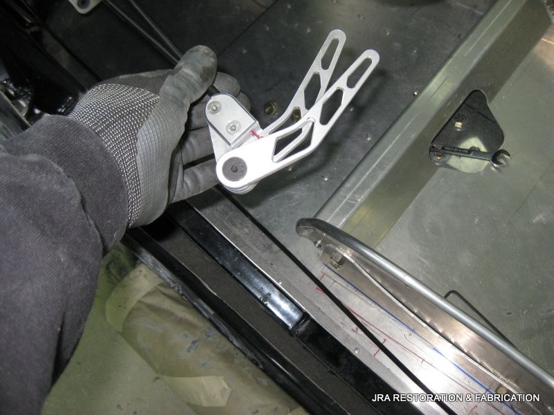 A person wearing gloves is holding a piece of metal