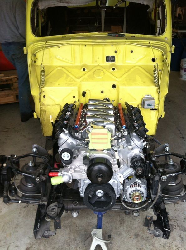 A yellow truck with a v8 engine under the hood