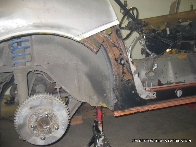 A car is being worked on by a company called restoration & cady cation