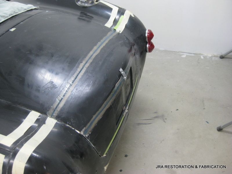 A black car is being restored by jra restoration & fabrication