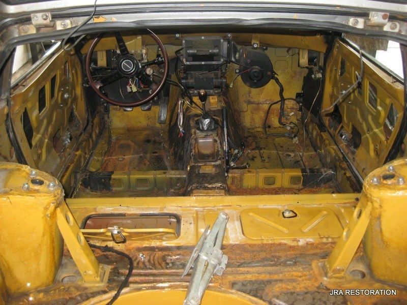 The inside of a yellow car with a steering wheel