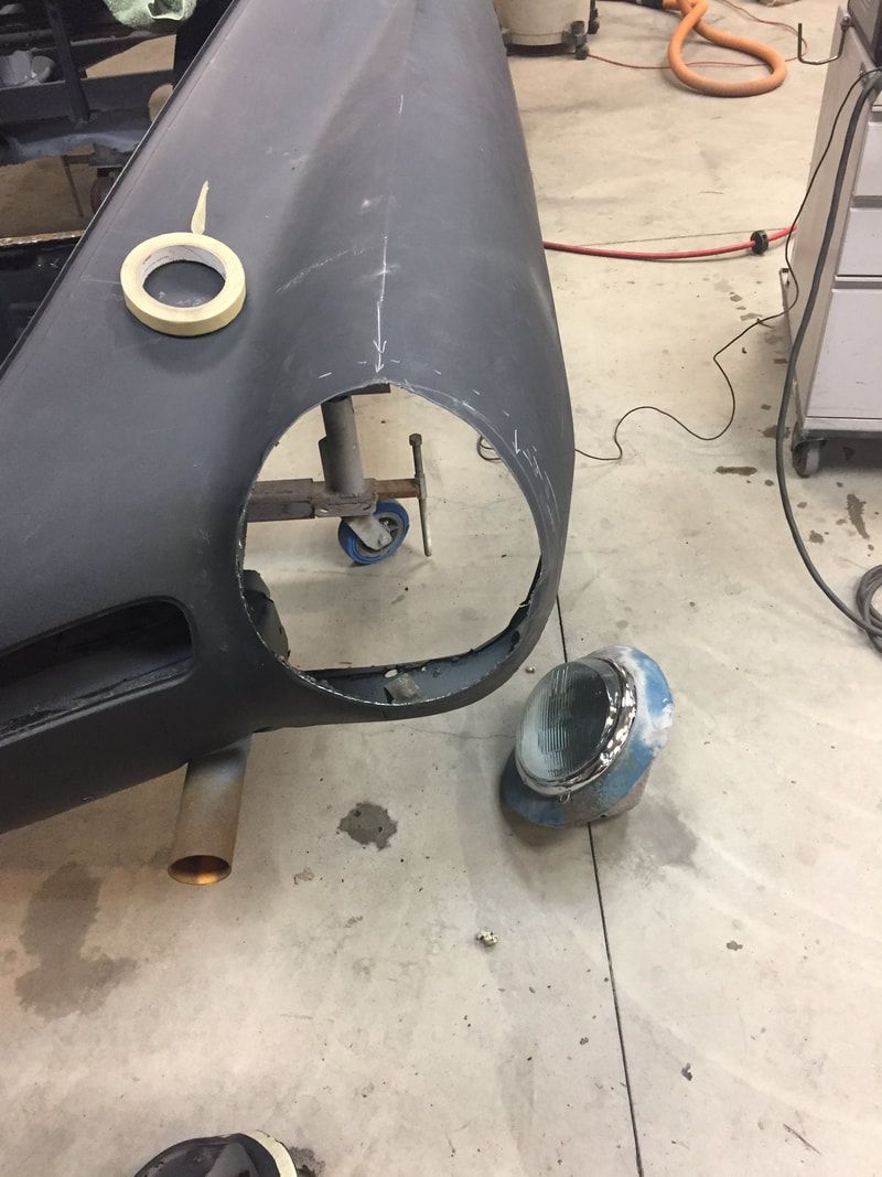 A car bumper with a hole in it and tape on it