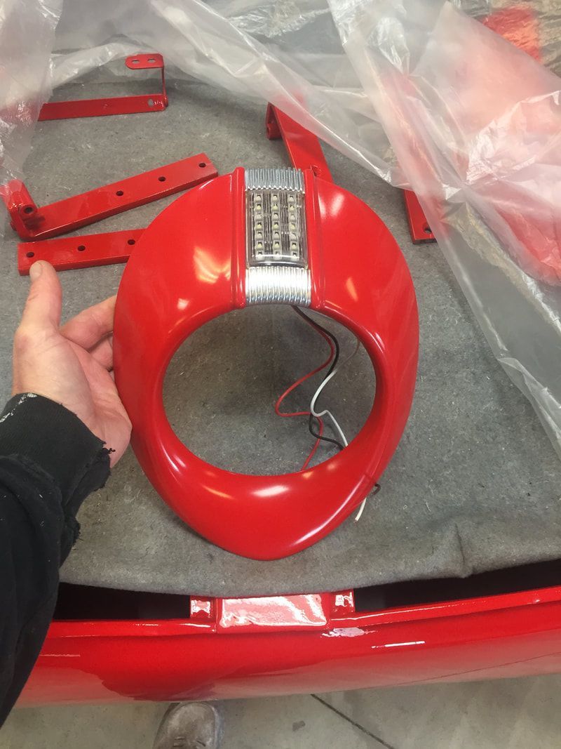 A person is holding a red object in their hand