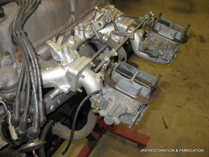 A close up of a carburetor on a car engine