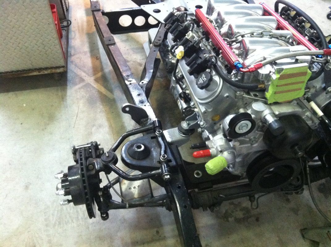 A close up of a car engine on a frame