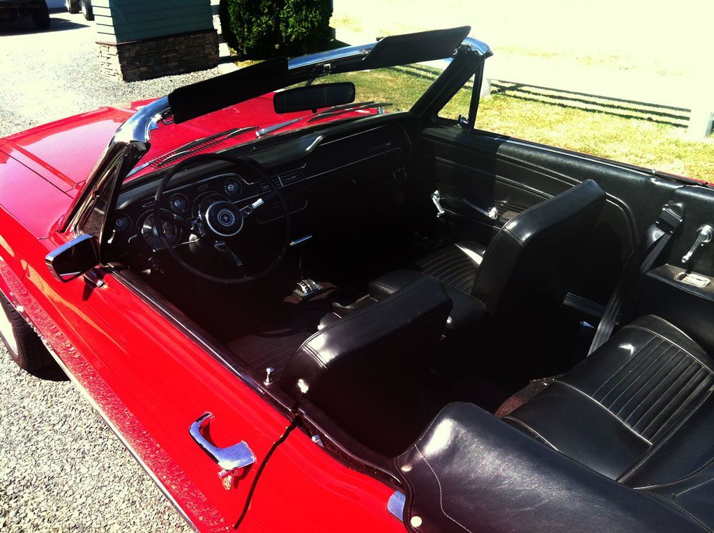 The inside of a red convertible with the top down