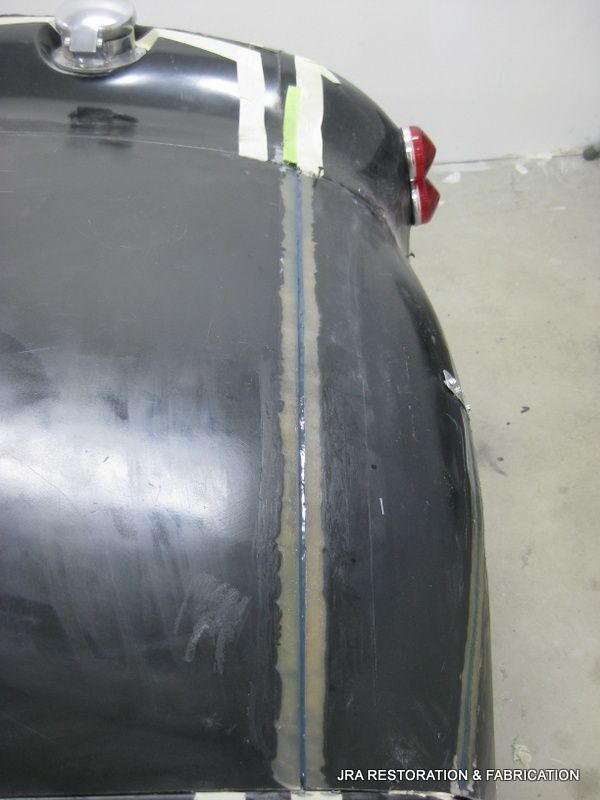 A black car is being restored by jra restoration & electrical