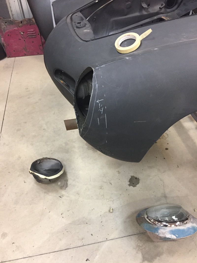 A close up of a car bumper with a piece of tape on it.