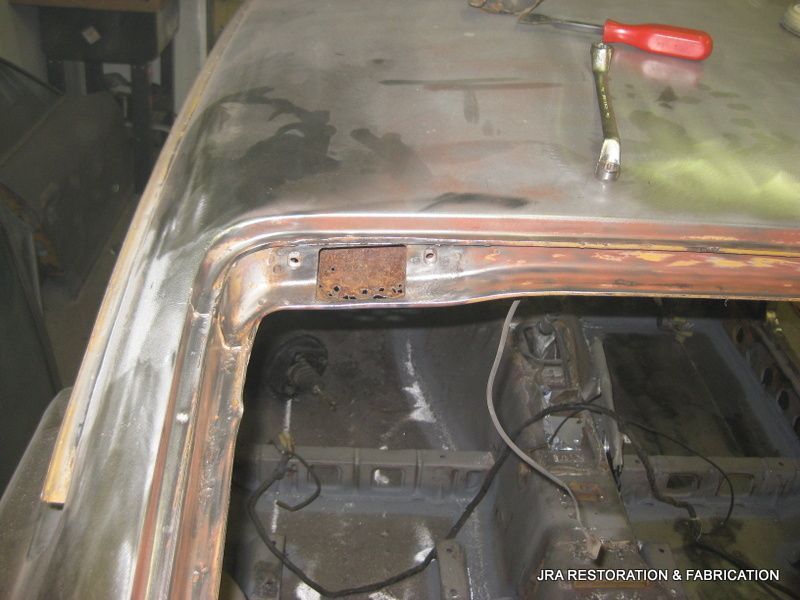 A screwdriver is sitting on the roof of a car