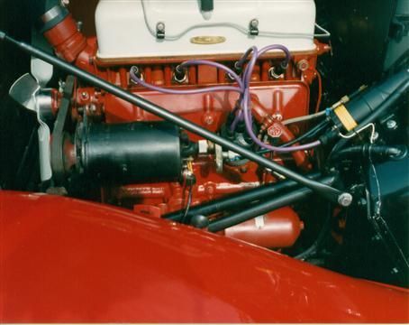 A close up of the engine of a red car