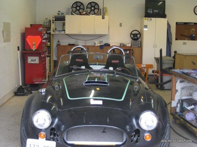 A black sports car with a license plate that says 173 on it