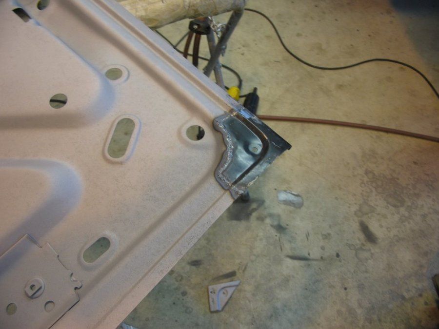 A piece of metal is being worked on on the floor