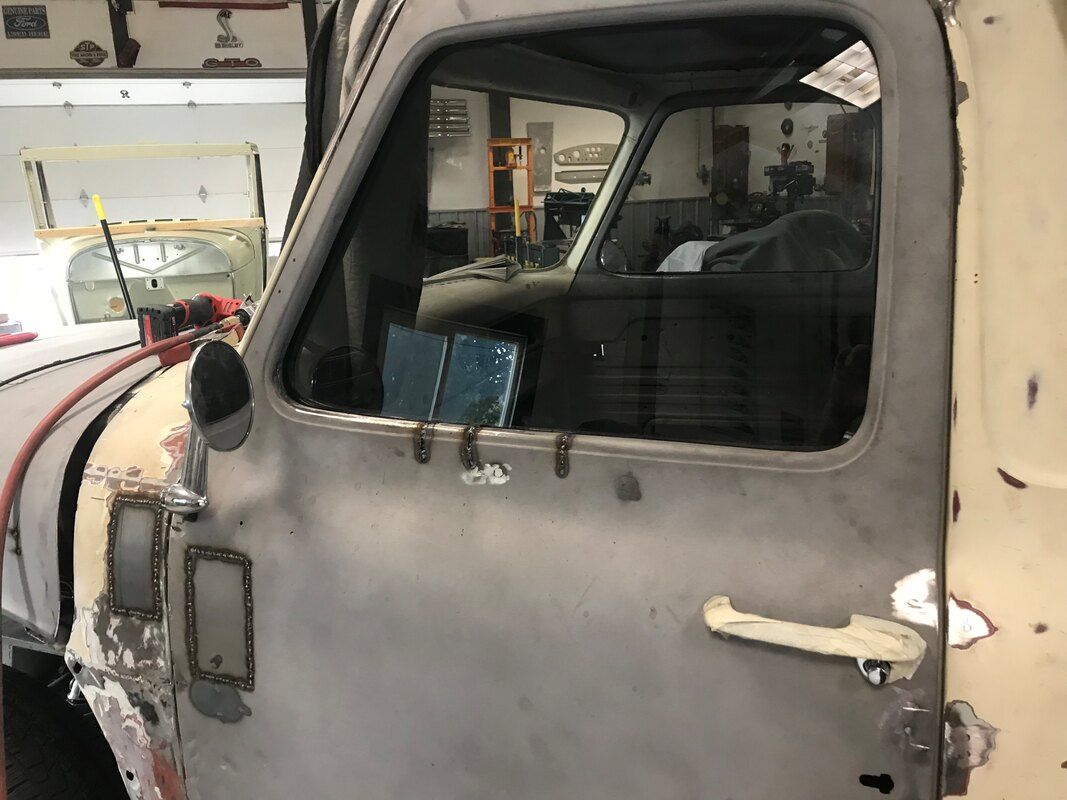 A close up of a truck door in a garage.
