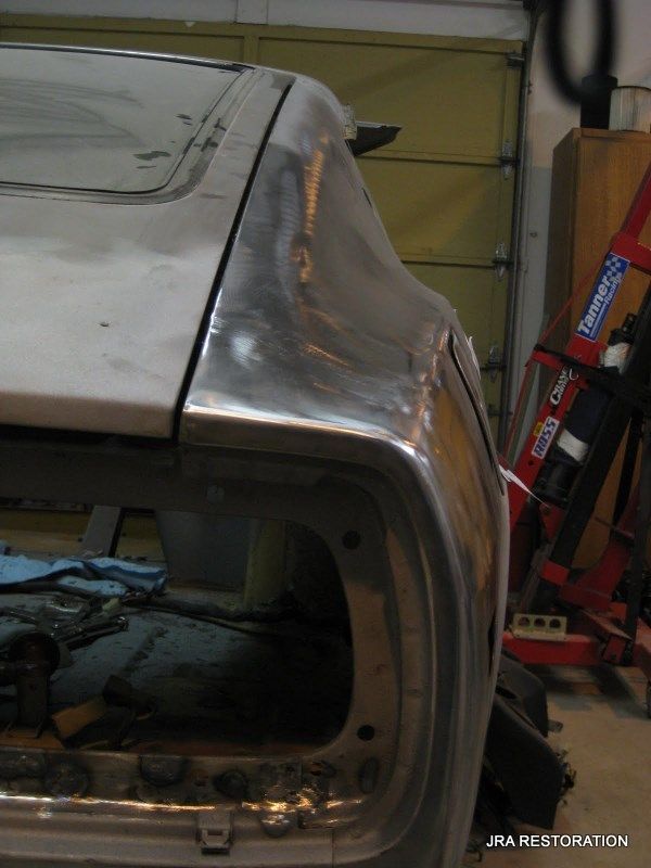 A silver car with the word restoration on the bottom