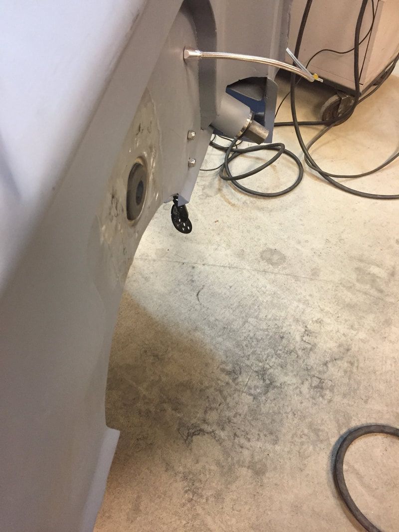 A bunch of wires are connected to a machine on the floor