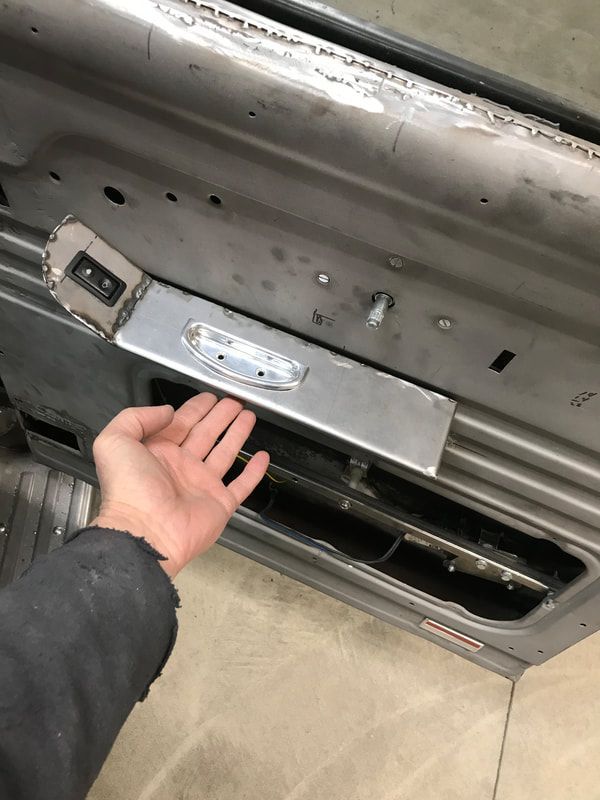 A person is holding a piece of metal in their hand.