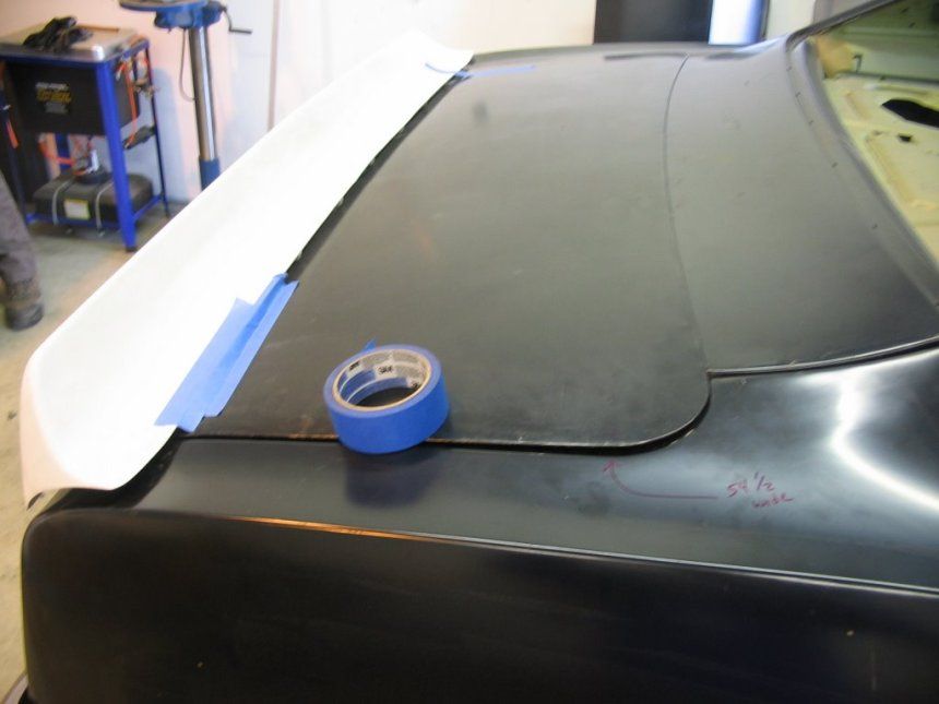 A roll of blue tape sits on a black surface