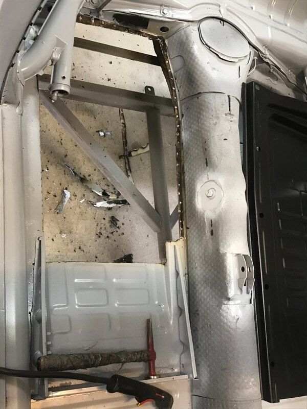 The inside of a car being worked on with tools