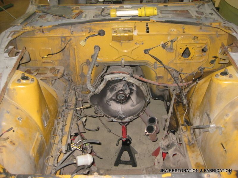 The inside of a yellow car with the letter a in the middle