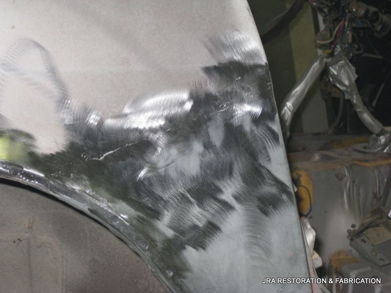 A close up of a car fender being painted
