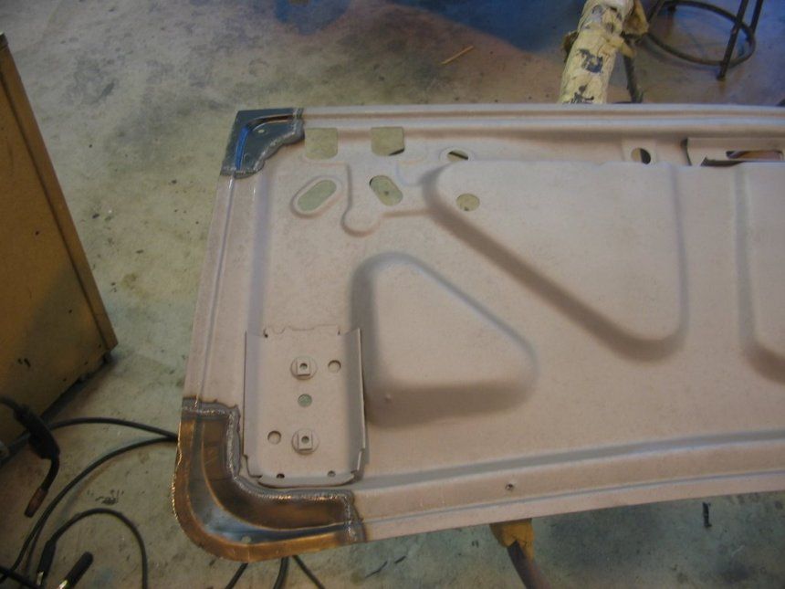 A piece of metal is sitting on top of a wooden table.