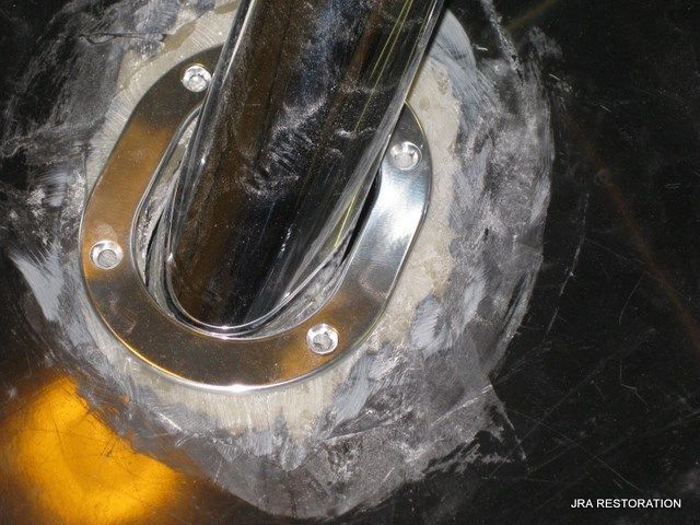 A close up of a metal pipe with a hole in it