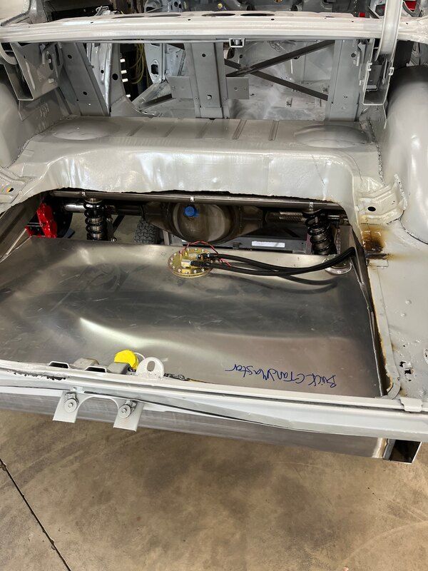 The trunk of a car with a fuel tank in it.