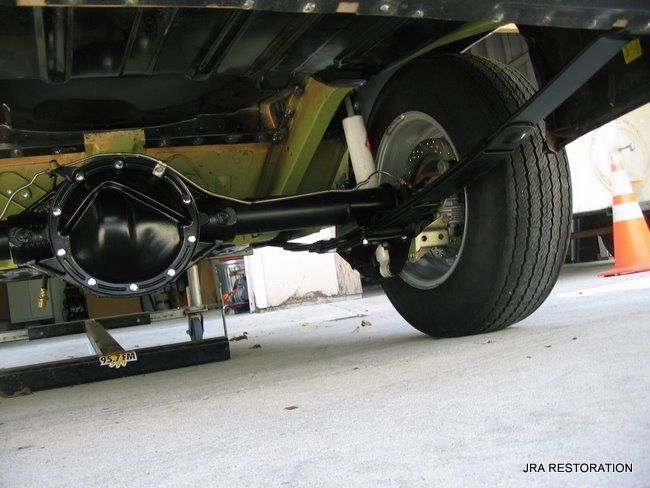 The rear axle of a car is shown in a photo taken by jra restoration