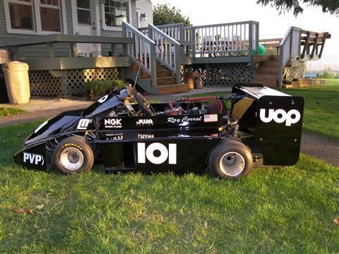 A black go kart with the number 101 on it