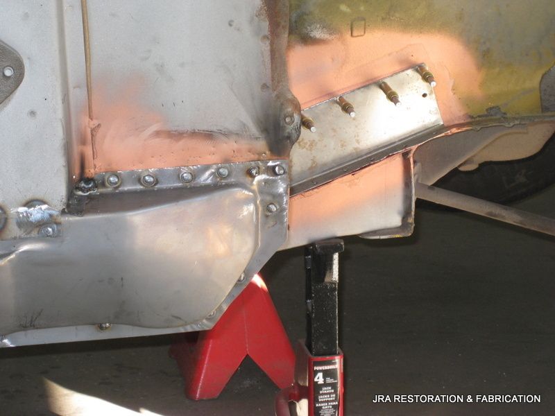 A piece of metal is sitting on a red jack stand