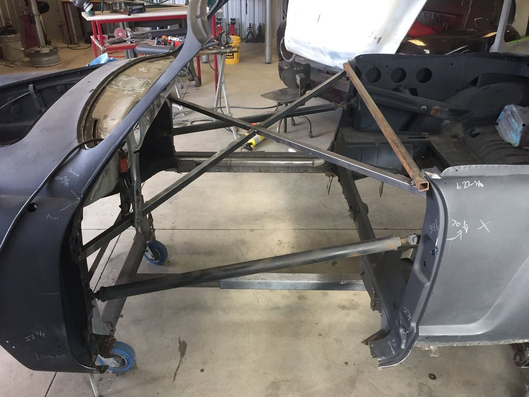 A car is being built in a garage.