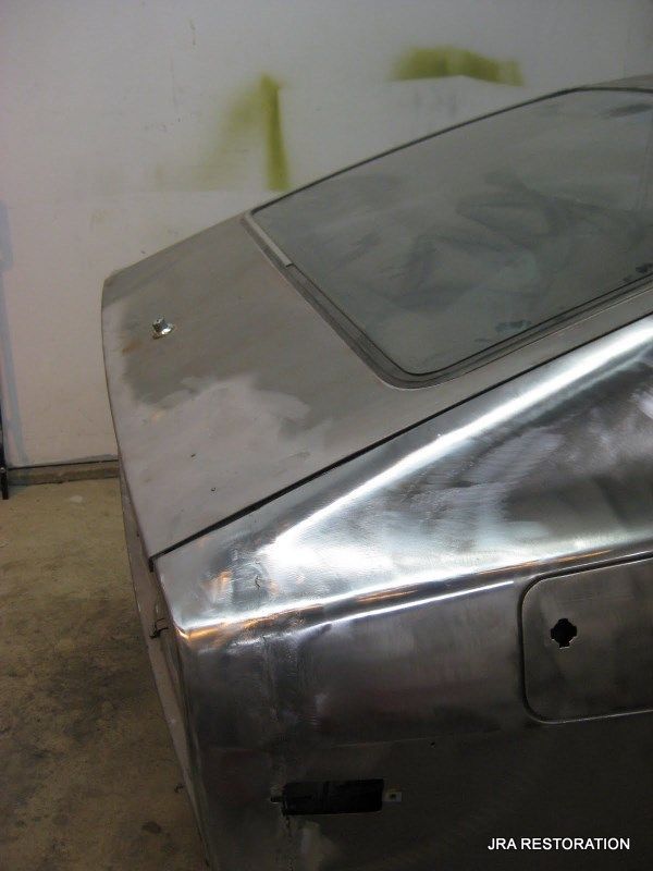 A silver car with the word restoration on the bottom