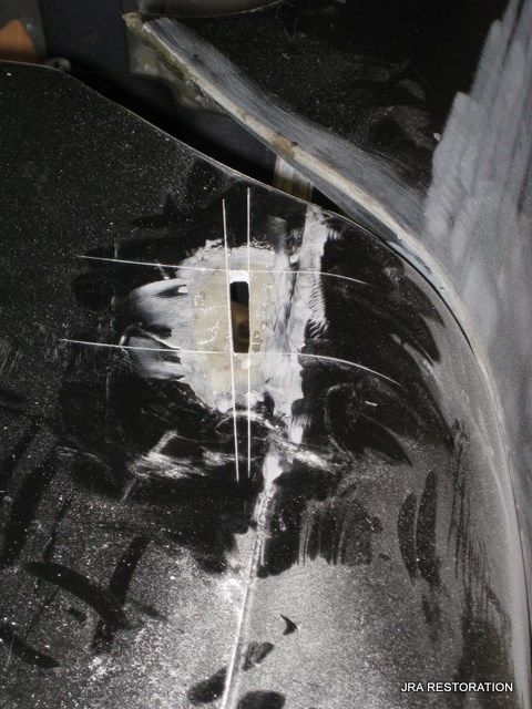 A black car with a hole in it and the words pa restoration on the bottom