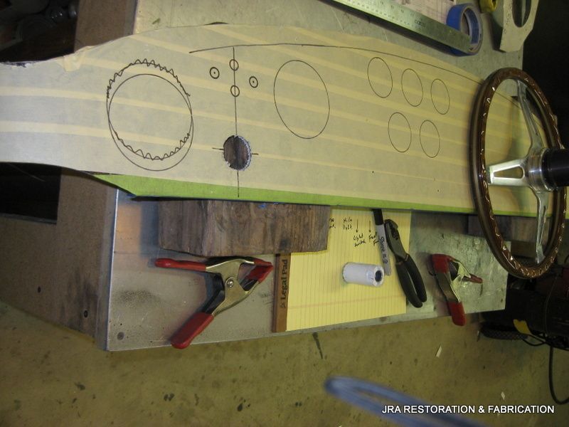 A piece of wood with circles drawn on it and a steering wheel