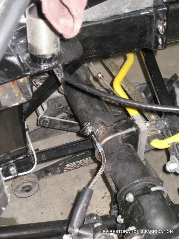 A close up of a car with a yellow hose attached to it